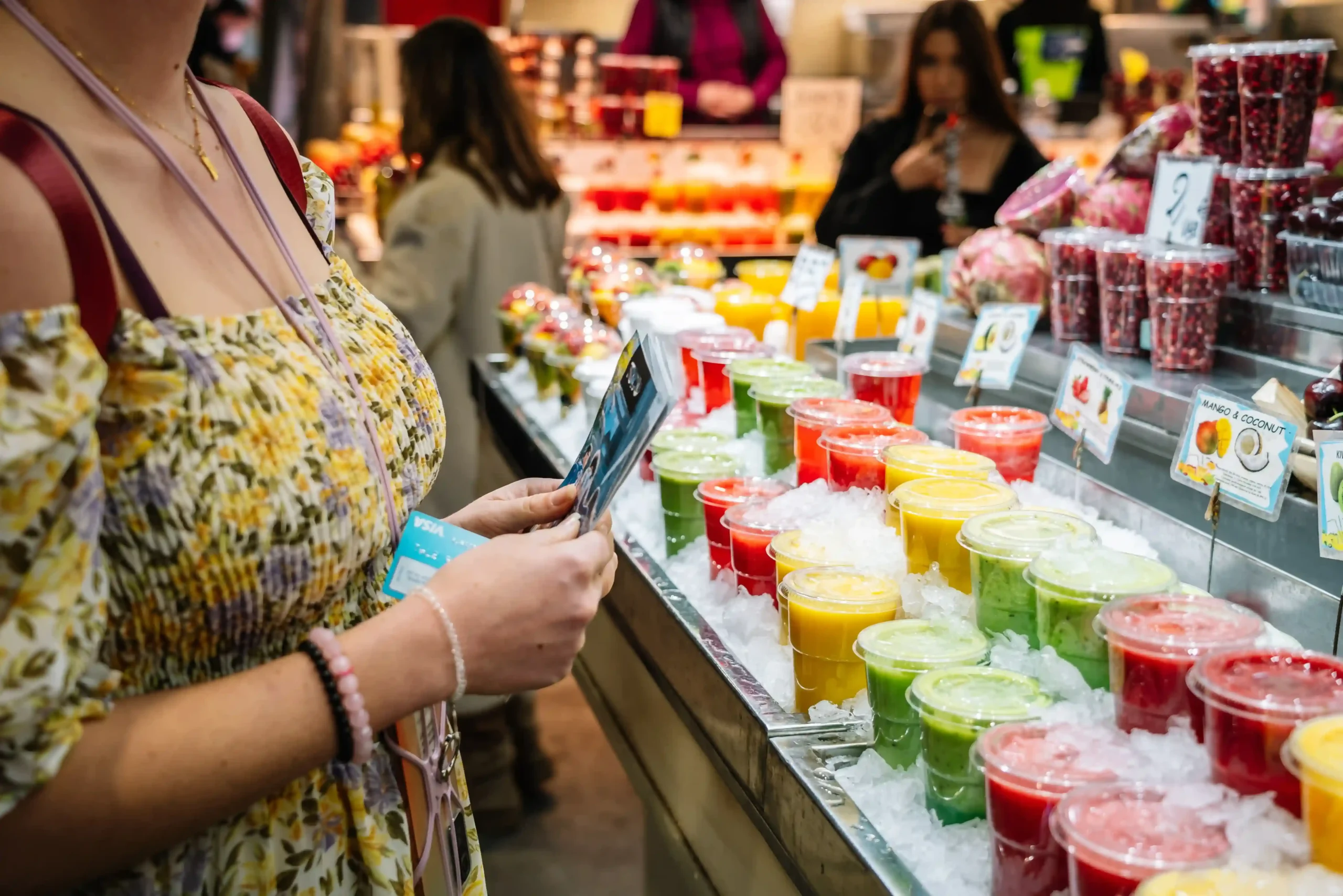woman-browsing-colorful-juice-drinks-at-market-sta-2026-01-07-02-16-06-utc.jpg_11zon-resized_11zon